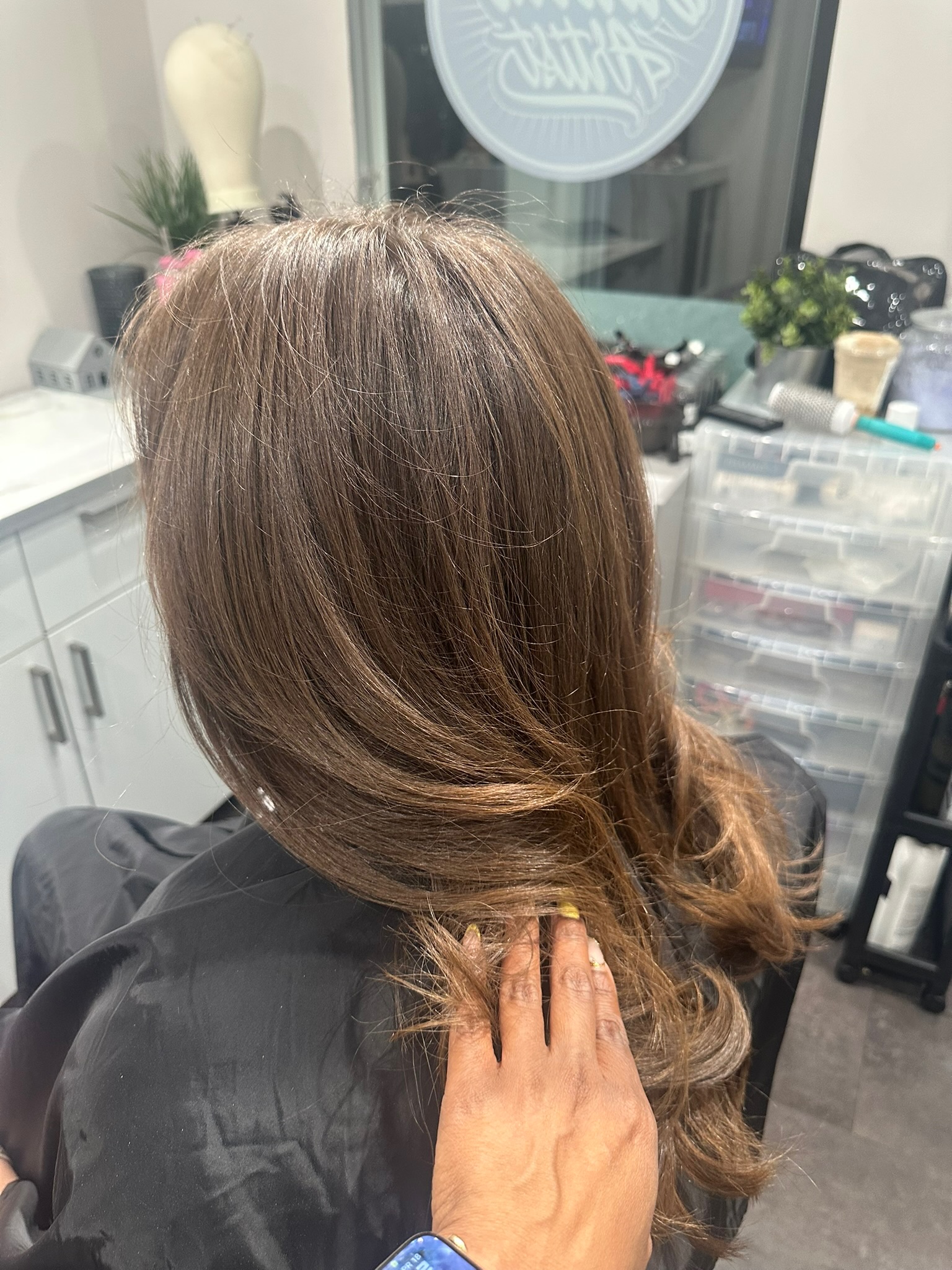 Client with a sleek silk press finish